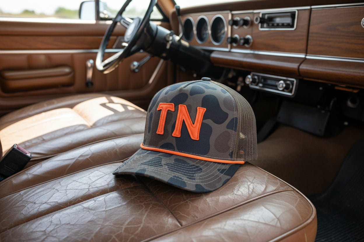tennessee camo hat with orange "TN" felt lettering and the hat is sitting inside a vintage car
